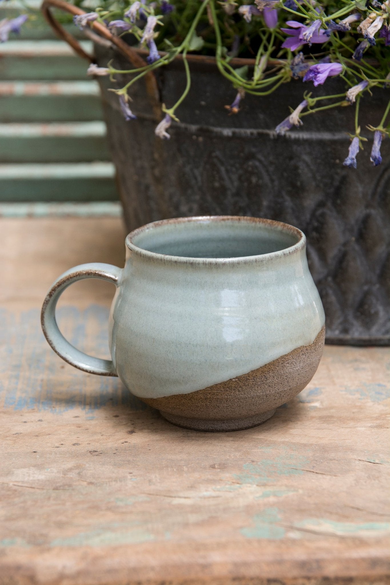 Wheel-thrown stoneware mugs with half-dipped glaze design.