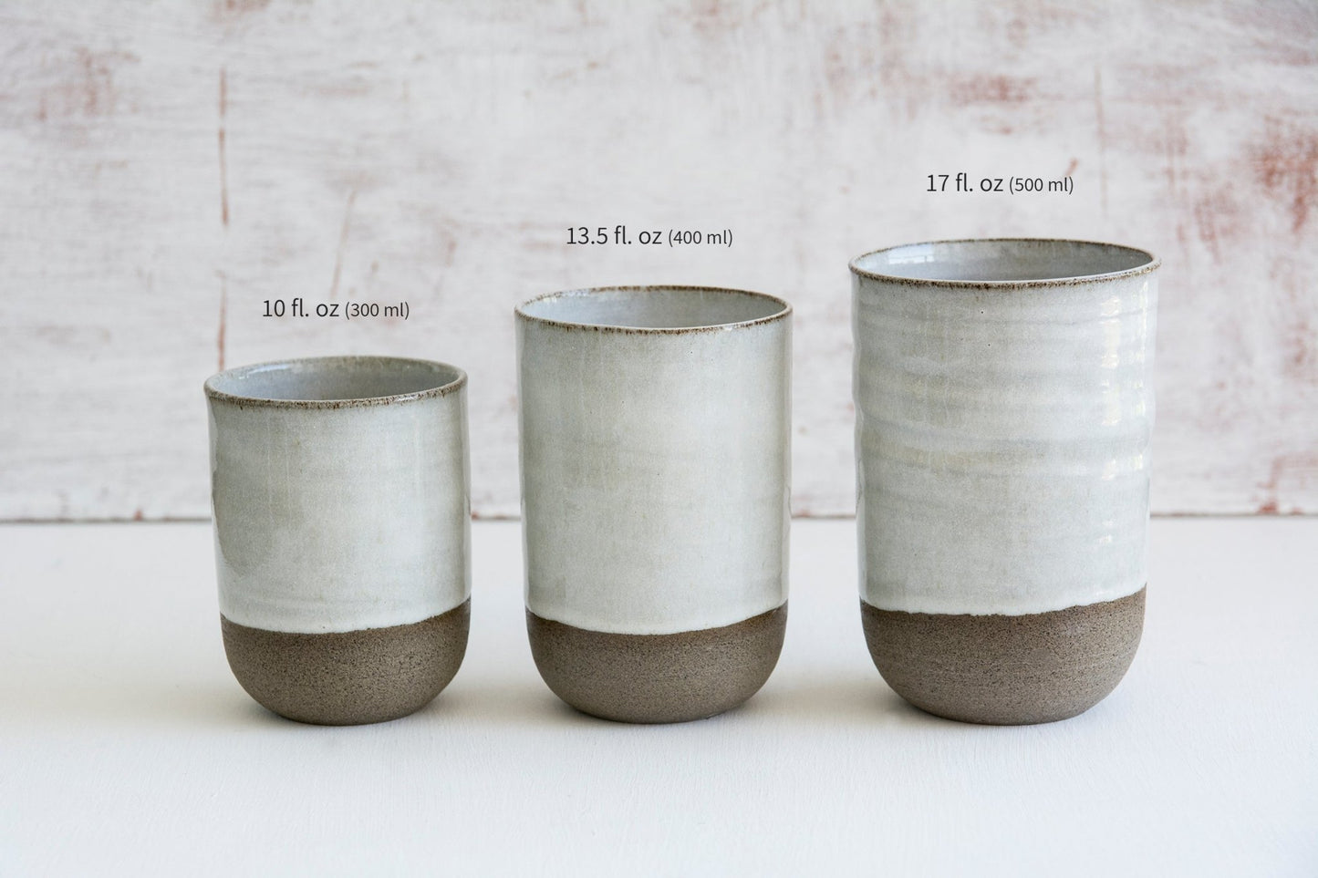 Three handmade pottery iced coffee tumblers in small, medium, and large sizes